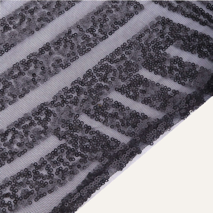 Black sequin fabric with a bold geometric pattern. #whtbkgd