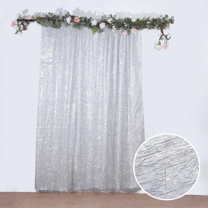 Shimmering silver curtain with floral garland