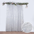 Shimmering silver curtain with floral garland