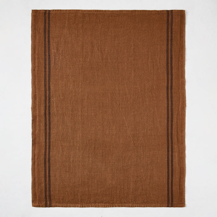 Brown French linen hand towel with two thin black stripes on each side.