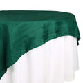 Green tablecloth elegantly draping over a white table.