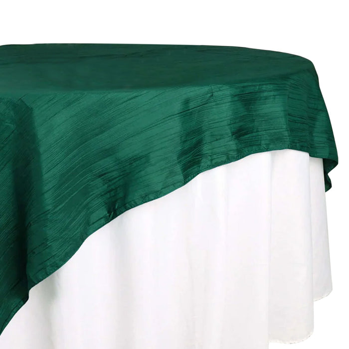 Green tablecloth elegantly draping over a white table.