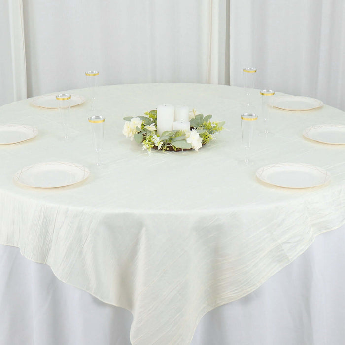 Elegant round table set with candles and floral centerpiece.